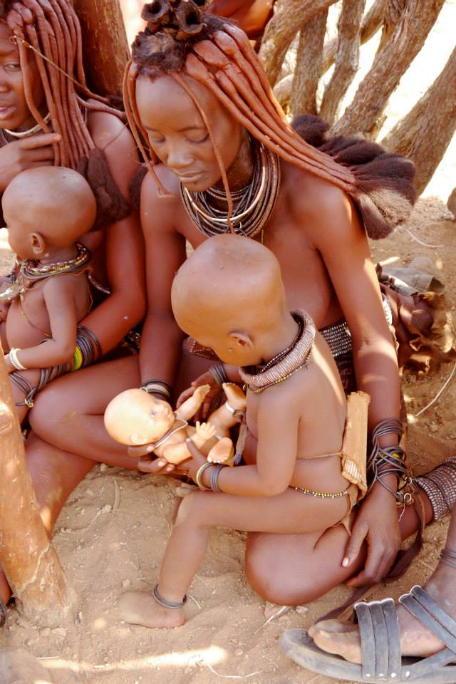 Himba family playing with doll