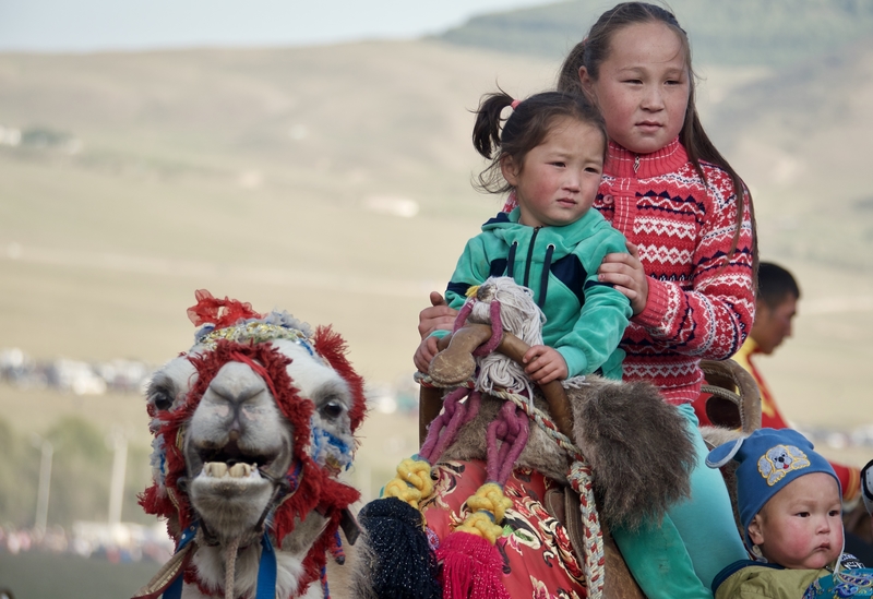 Nomadic girls on camels at the World Nomad Games in Kyrgyzstan