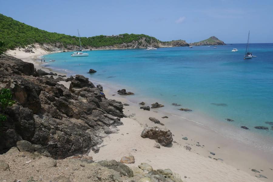 Beautiful St Barths beach with clear turquoise waters and sailboats. Perfect for a day trip from St.